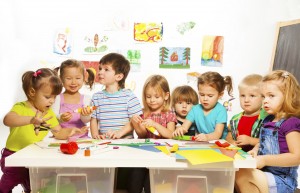 Many kids drawing and gluing